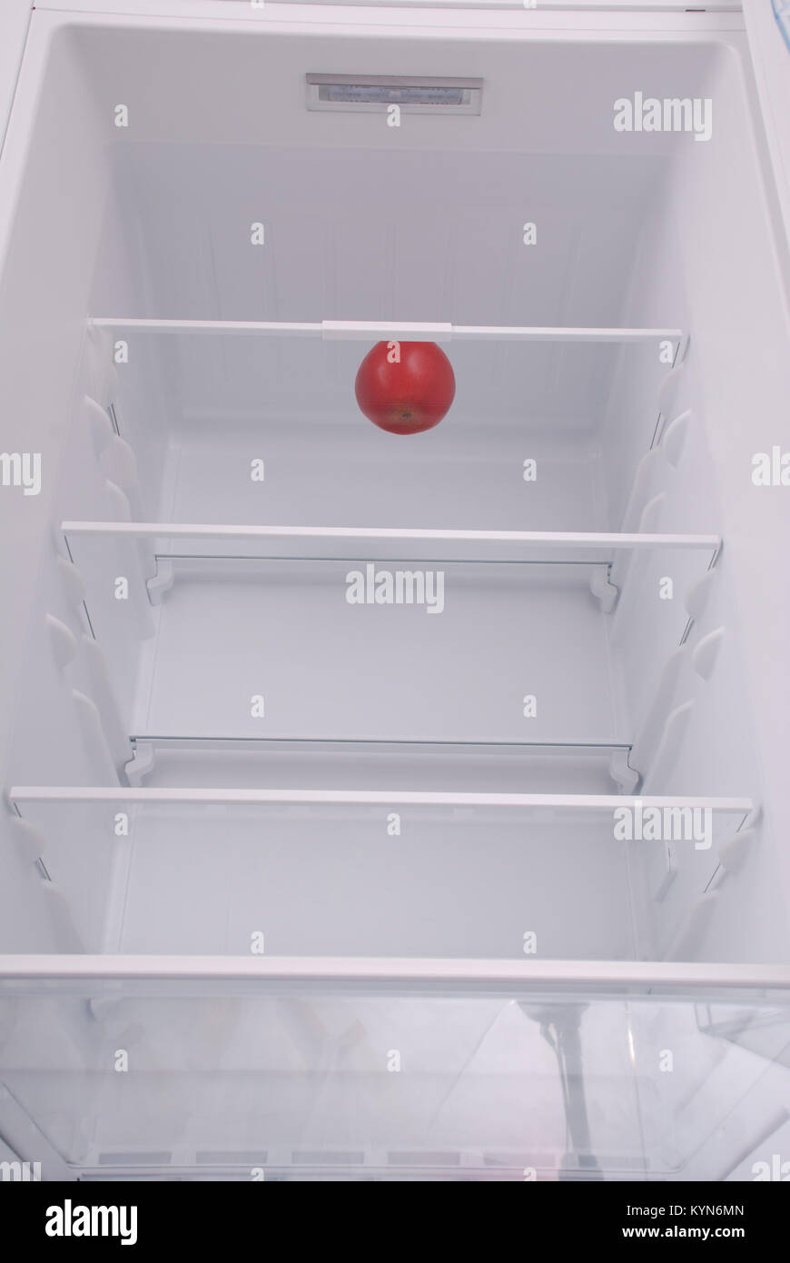 One apple in open empty refrigerator. Weight loss diet concept Stock