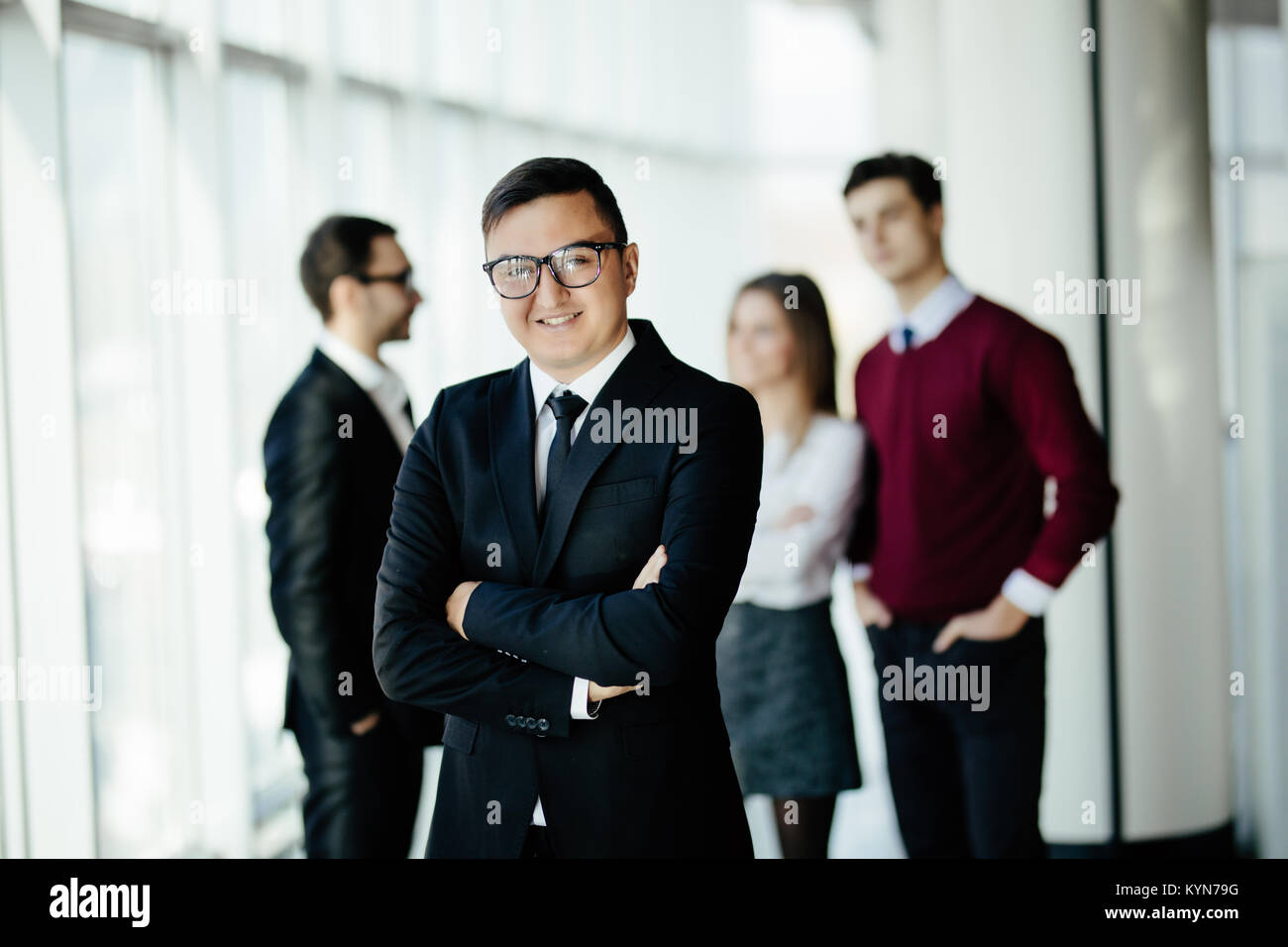 Portrait of an handsome businessman in front of his team Stock Photo ...