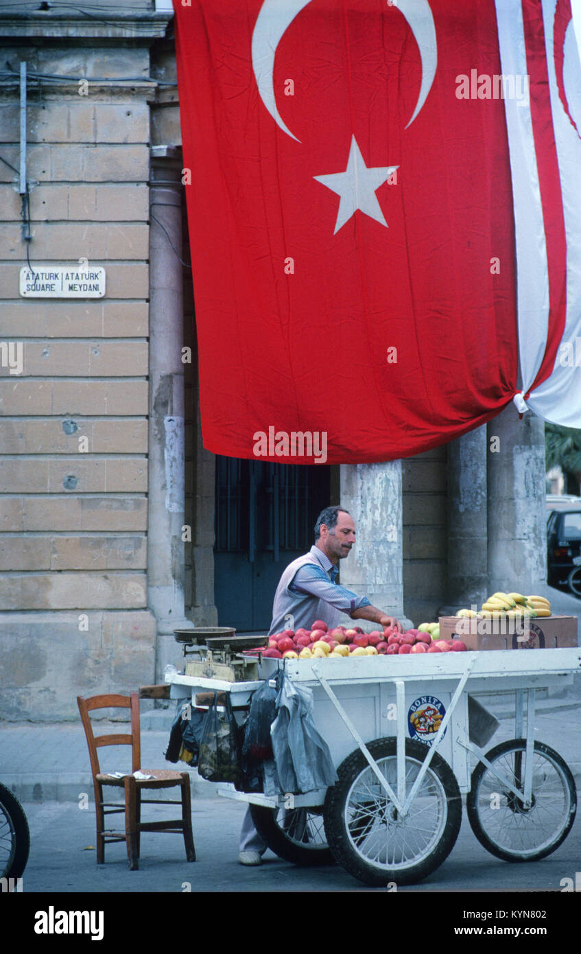 Street Seller, Vendor or Hawker Selling Fruit from Barrow and Turkish Flag, Lefkosa or North Nicosia, Northern Cyprus Stock Photo