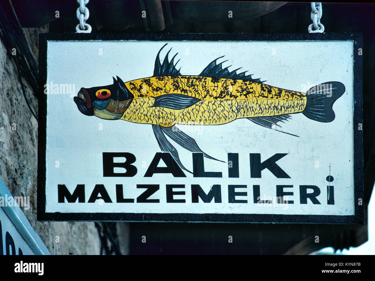 Hanging Sign Advertising a Fish Restaurant and Fishmongers or Fish Shop on the Harbour Front or Port, Girne or Kyrenia, Northern Cyprus Stock Photo