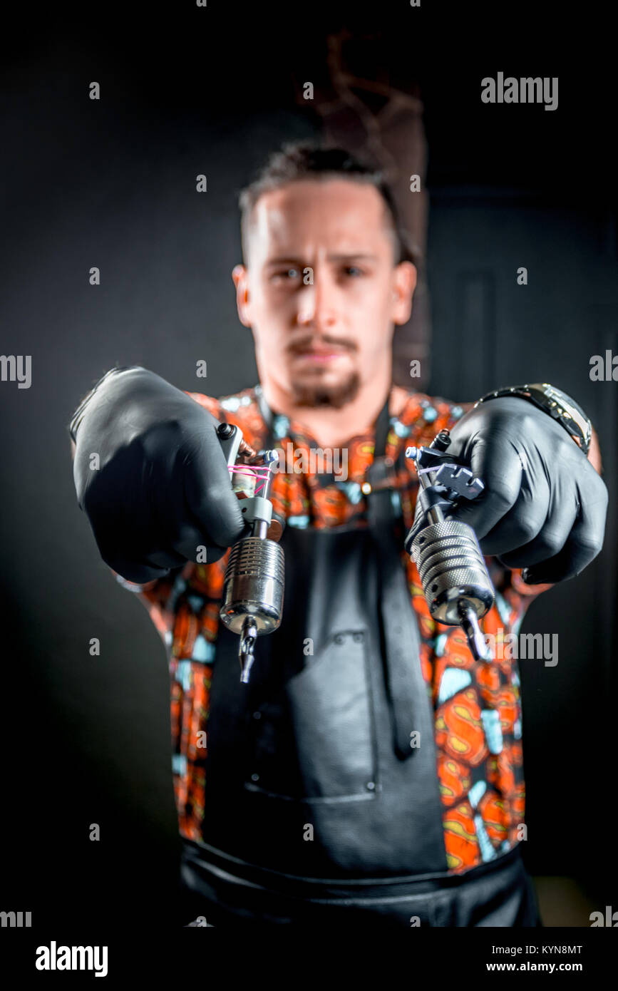 Tattoo artist poses in a studio Stock Photo Alamy
