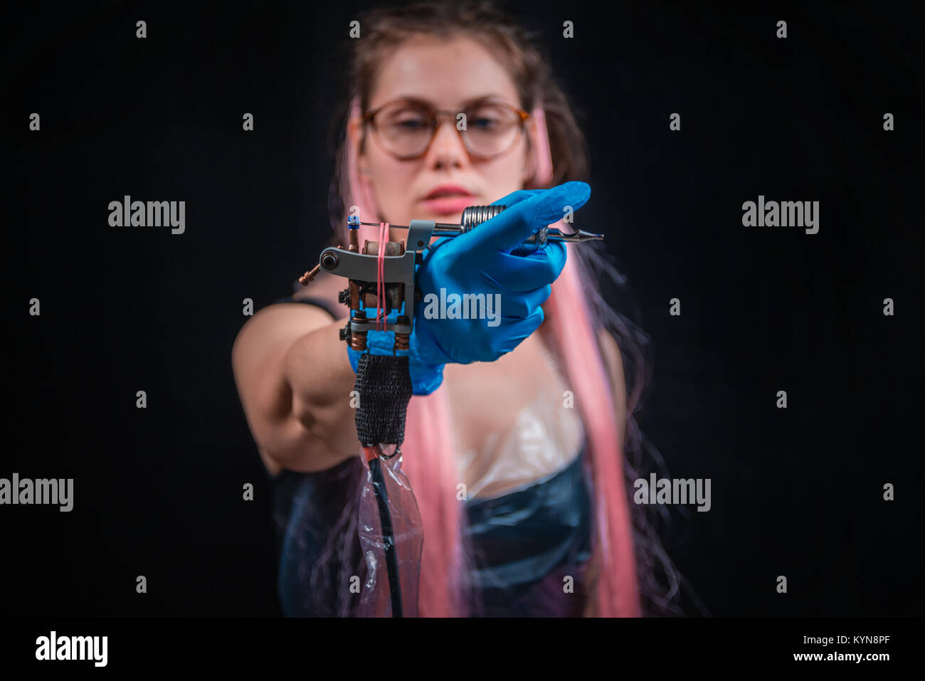 Tattoo artist with a tattoomachine in studio Stock Photo Alamy