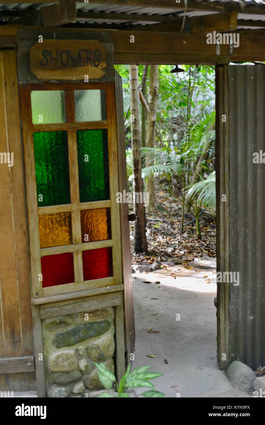 Shower with coloured glass door in a rainforest hires stock