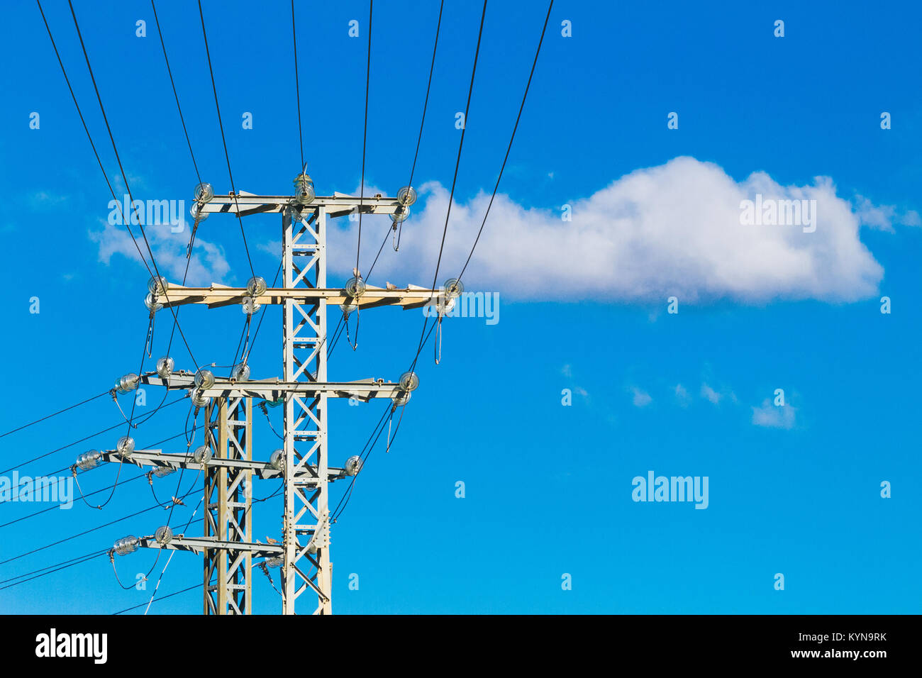 High voltage power lines and electric transmission pylon with blue sky ...