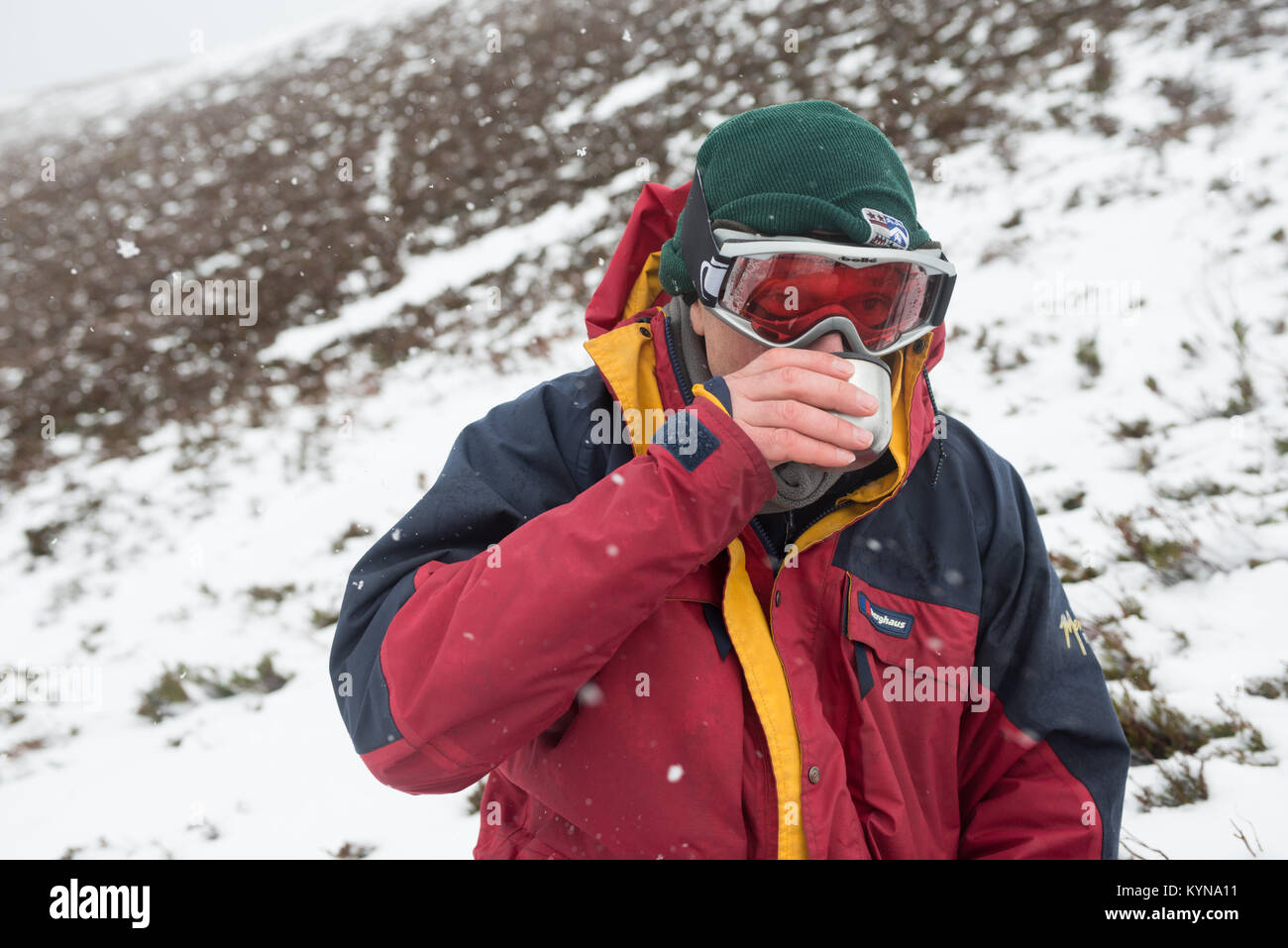 Drinking hot liquids is a good way to keep warm when walking in winter conditions Stock Photo
