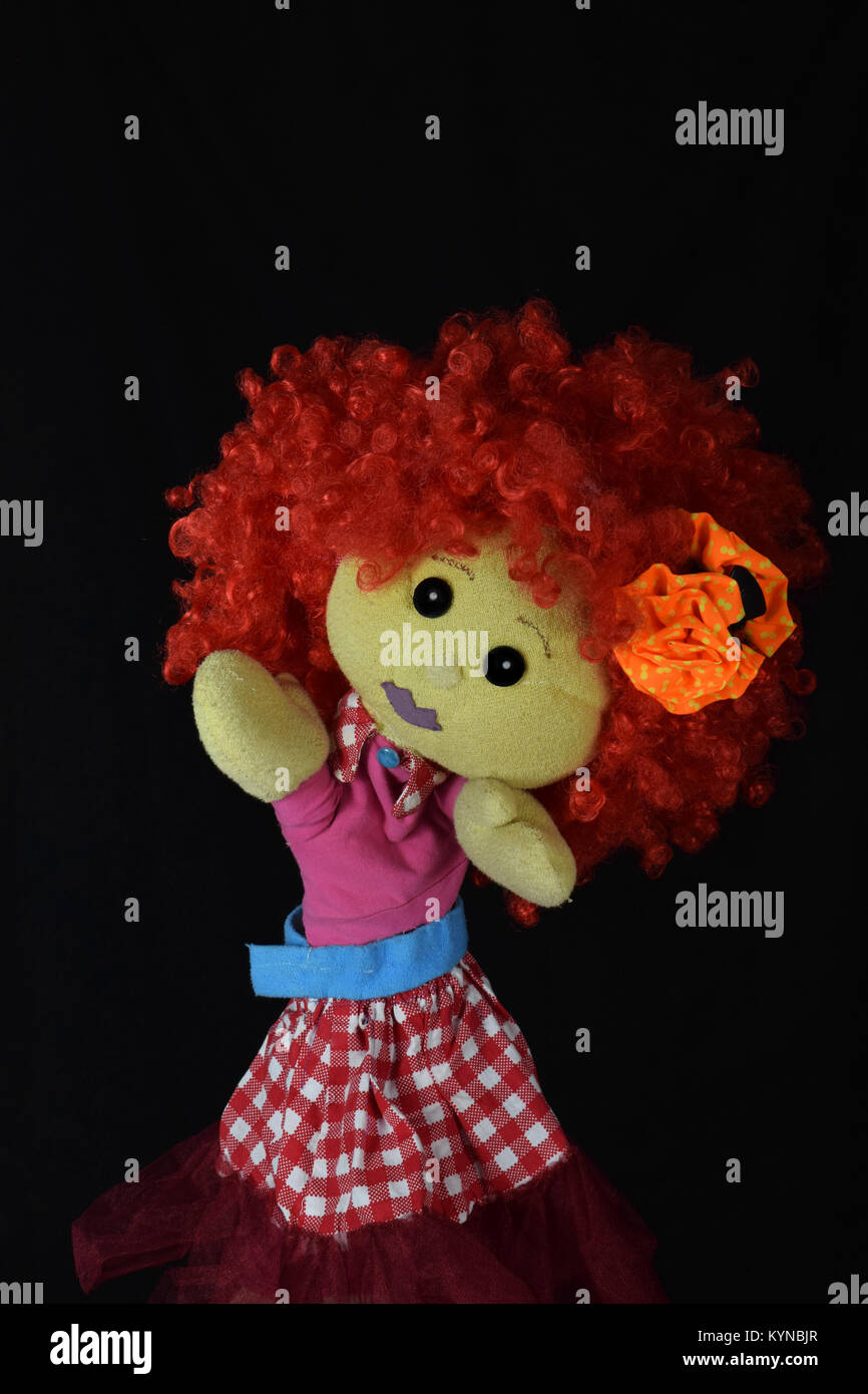 red hair puppet girl on black background Stock Photo Alamy