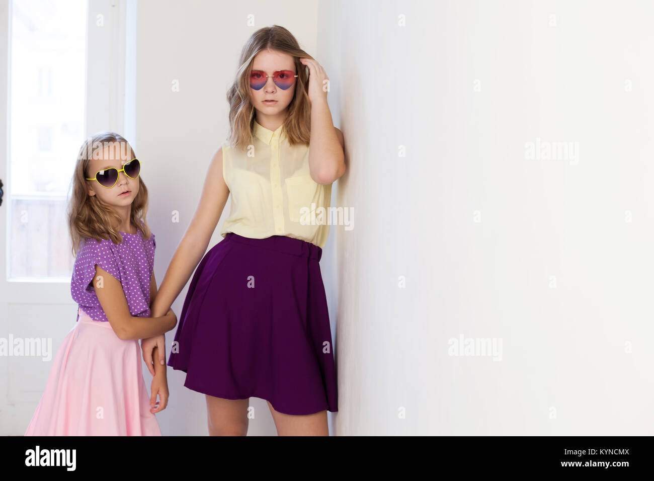 two girls in glasses from the Sun in a white room Stock Photo - Alamy
