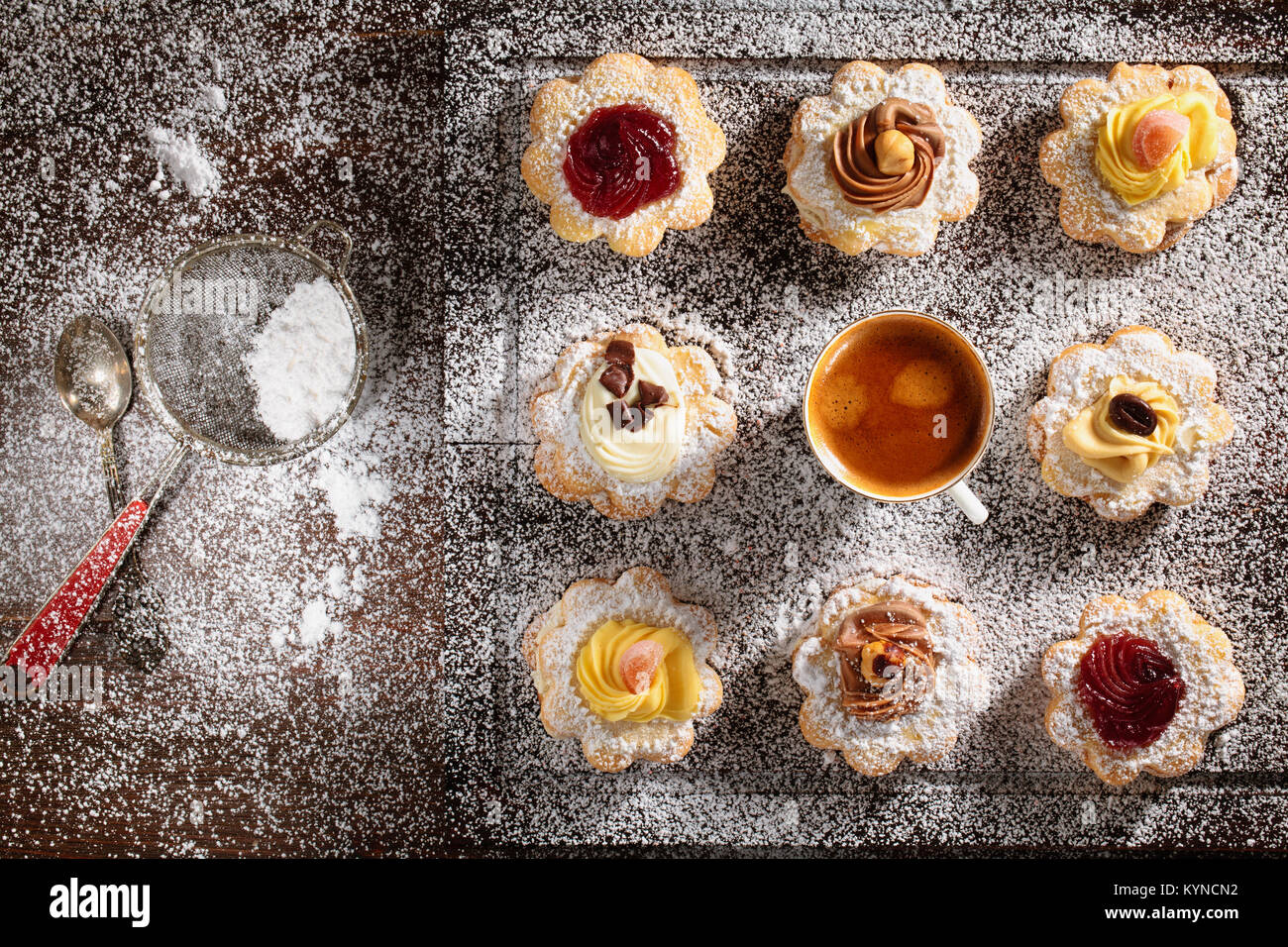 Cookies with jelly, cream and powdered sugar. Stock Photo
