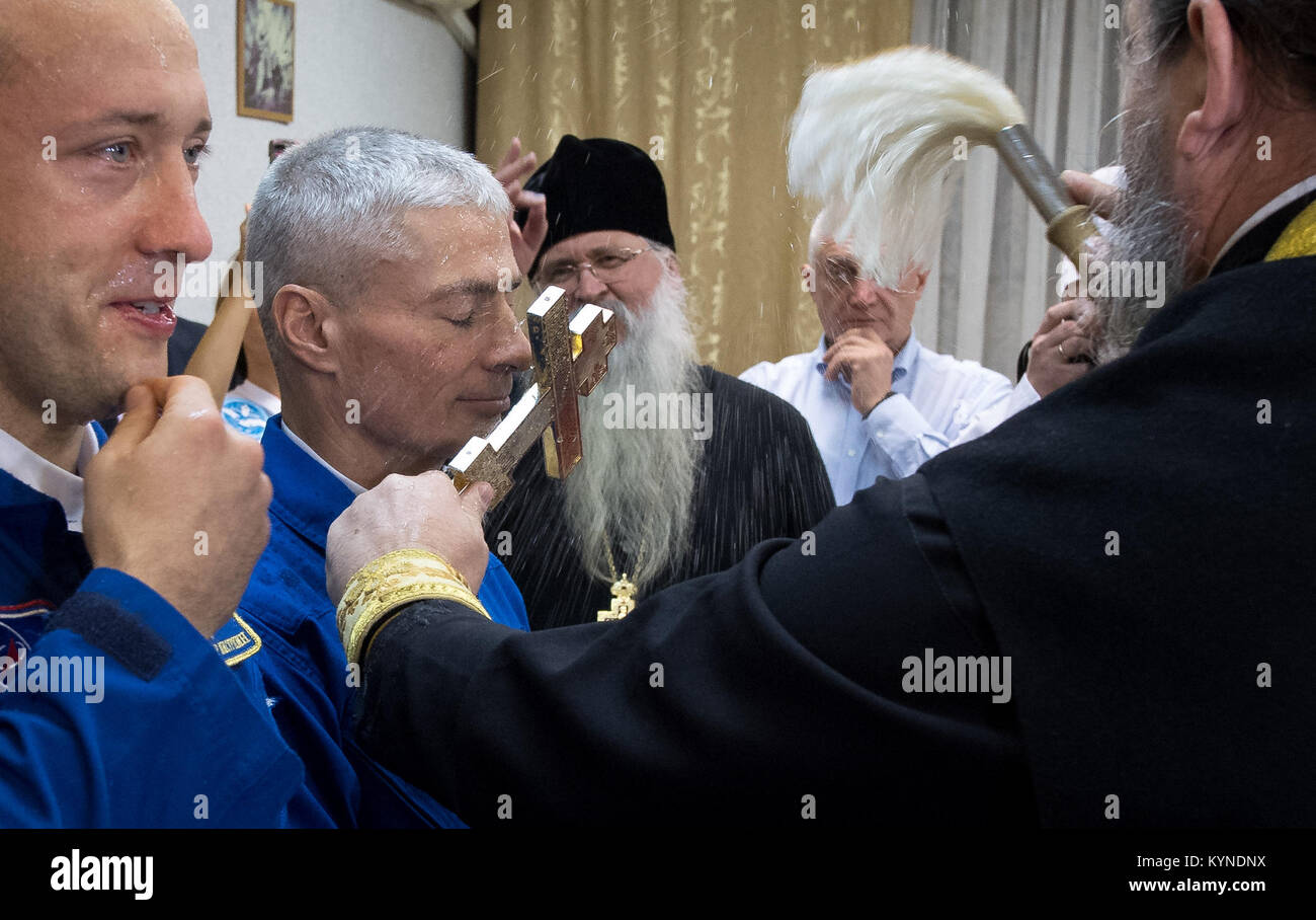Russian Orthodox Priest, father Sergei, right, blesses Expedition 53 Mark Vande Hei of NASA, right, ahead of his launch onboard a Soyuz MS-06 spacecraft with Expedition 53 flight engineer Joe Acaba of NASA, and Expedition 53 Soyuz Commander Alexander Misurkin of Roscosmos Tuesday, Sept. 12, 2017 at the Cosmonaut Hotel in Baikonur, Kazakhstan. Acaba, Misurkin, and Vande Hei will spend approximately five and half months on the International Space Station. Photo Credit: (NASA/Bill Ingalls) Stock Photo