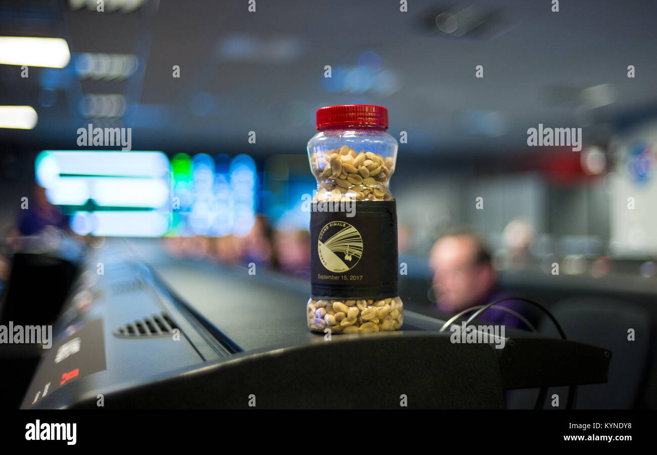 A jar of peanuts is seen sitting on a console in mission control of the Space Flight Operations Center as the Cassini mission team await the final downlink of the spacecraft's data recorder, Thursday, Sept. 14, 2017 at NASA's Jet Propulsion Laboratory in Pasadena, California. Since its arrival in 2004, the Cassini-Huygens mission has been a discovery machine, revolutionizing our knowledge of the Saturn system and captivating us with data and images never before obtained with such detail and clarity. On Sept. 15, 2017, operators will deliberately plunge the spacecraft into Saturn, as Cassini ga Stock Photo