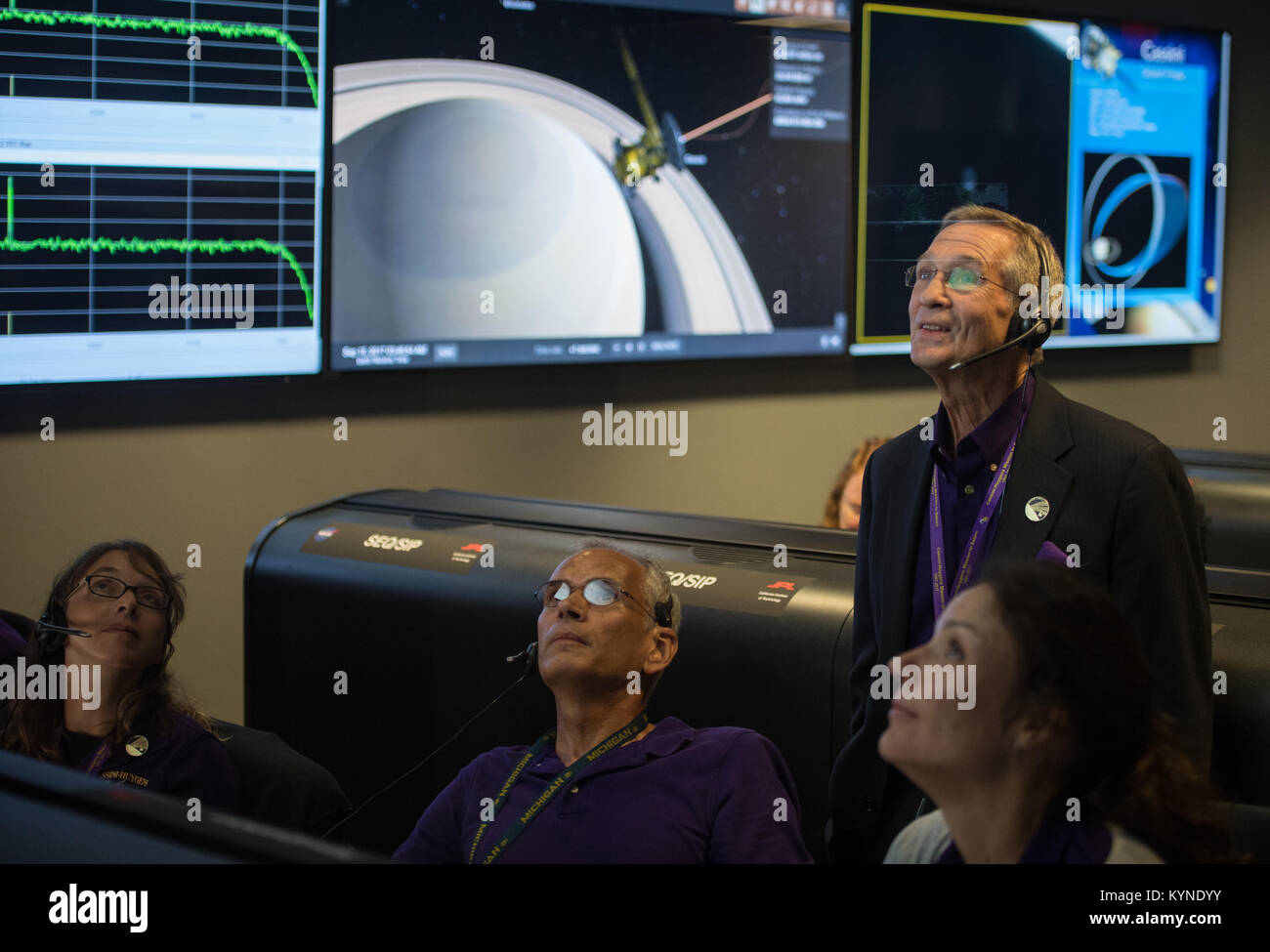 Cassini program manager at JPL, Earl Maize, standing, watches telemetry come in from Cassini with Julie Bellerose, left, Duane Roth, second from left, and Mar Vaquero of the Cassini navigation team in the mission control room, Friday, Sept. 15, 2017 at NASA's Jet Propulsion Laboratory in Pasadena, California. Since its arrival in 2004, the Cassini-Huygens mission has been a discovery machine, revolutionizing our knowledge of the Saturn system and captivating us with data and images never before obtained with such detail and clarity. On Sept. 15, 2017, operators deliberately plunged the spacecr Stock Photo