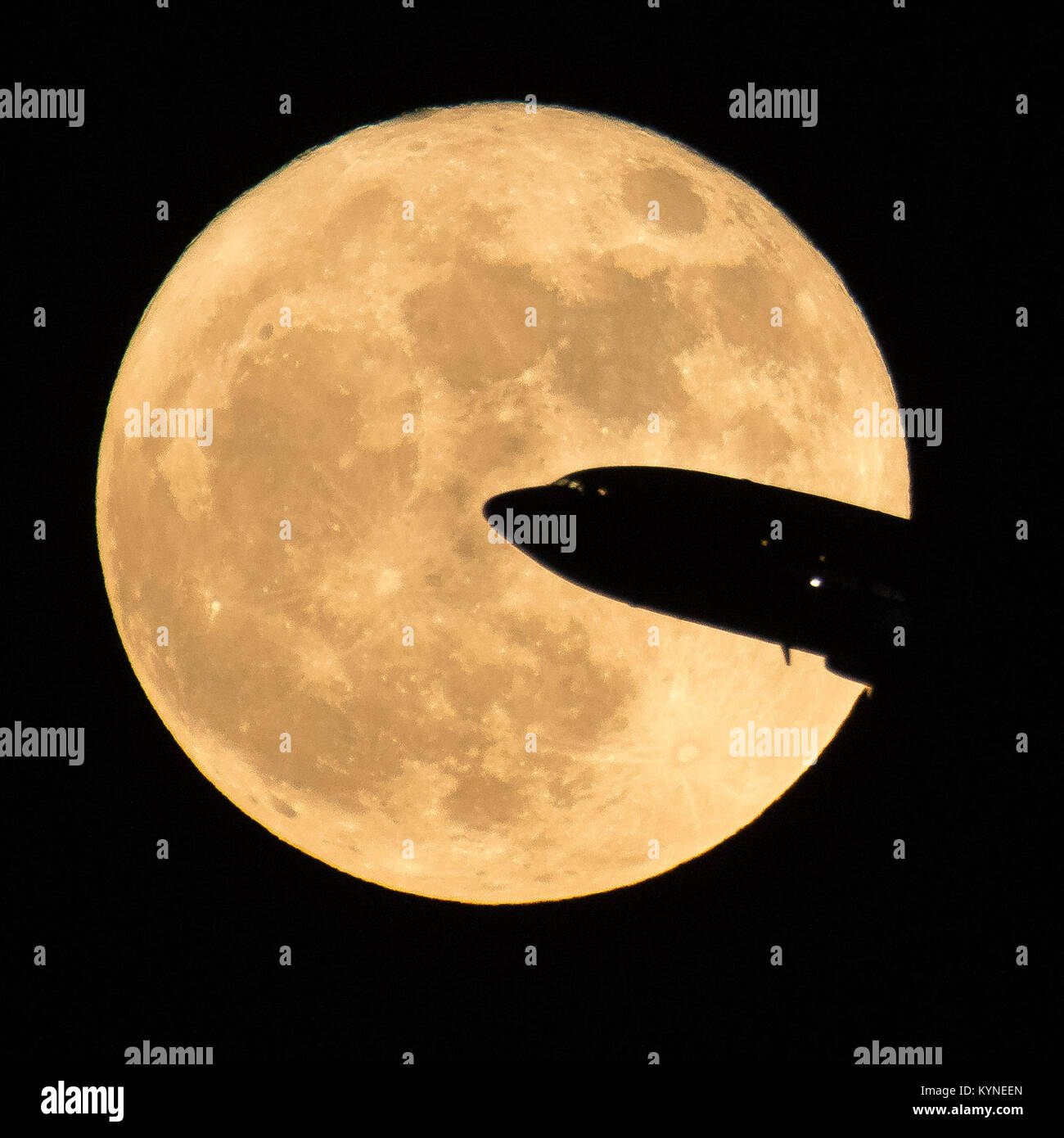 A full moon rises over Washington, DC, while an aircraft takes off from Ronald Reagan National Airport, capturing the spectacle of a supermoon as part of NASA's ongoing research into lunar phenomena. Stock Photo