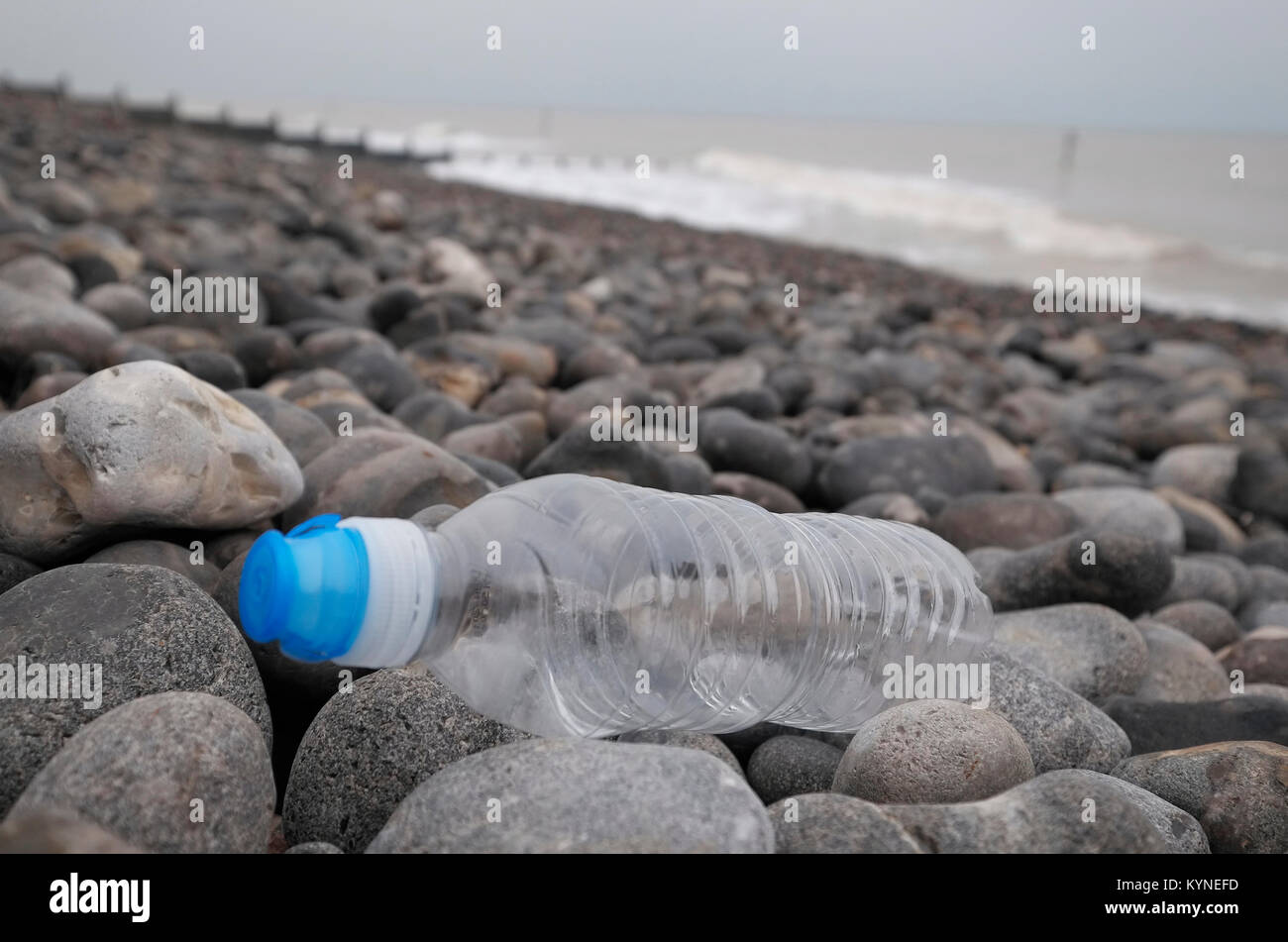 plastic water bottle washed up on shingle beach, sheringham, north norfolk, england Stock Photo