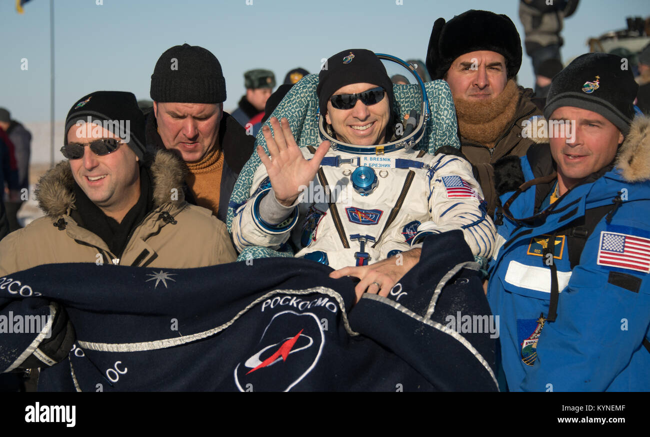 NASA astronaut Randy Bresnik is carried to the medical tent by, Deputy Manager of the International Space Station Program Joel Montalbano, left, and NASA astronaut Reid Wiseman, right, shortly after he and ESA (European Space Agency) astronaut Paolo Nespoli, and Roscosmos cosmonaut Sergey Ryazanskiy landed in their Soyuz MS-05 spacecraft in a remote area near the town of Zhezkazgan, Kazakhstan on Thursday, Dec. 14, 2017. Bresnik, Nespoli and Ryazanskiy are returning after 139 days in space where they served as members of the Expedition 52 and 53 crews onboard the International Space Station. P Stock Photo