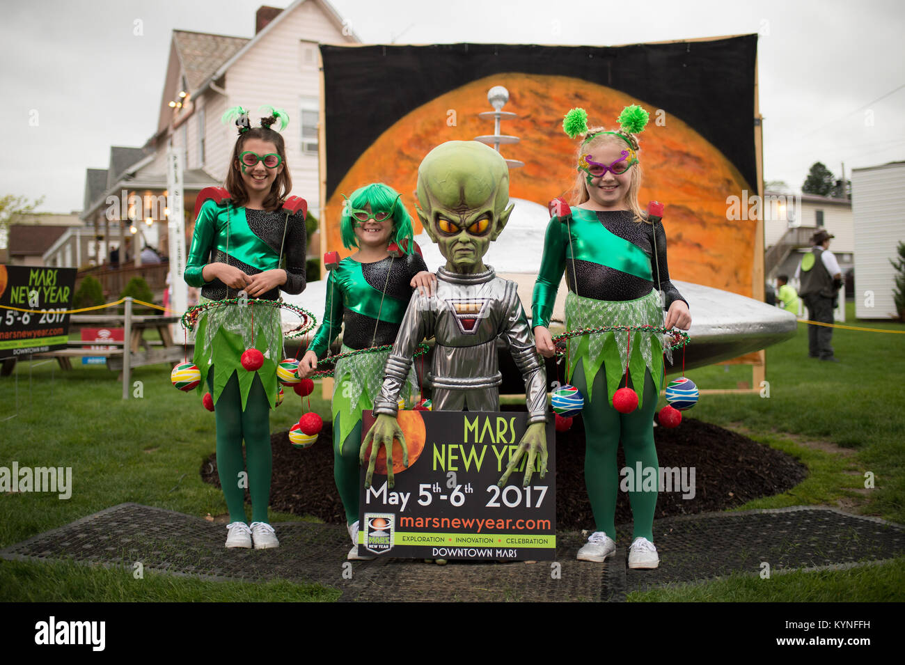 Arabella Wojnar, left, Bianca Wojnar, and Valentina Wojnar, right, pose for a photograph with a model of a spacecraft and alien during the Mars New Year celebration Friday, May 5, 2017, in Mars, Pennsylvania. The town is hosting two days of Science, Technology, Engineering, Arts and Mathematics (STEAM) activities. Photo Credit: (NASA/Bill Ingalls) Stock Photo