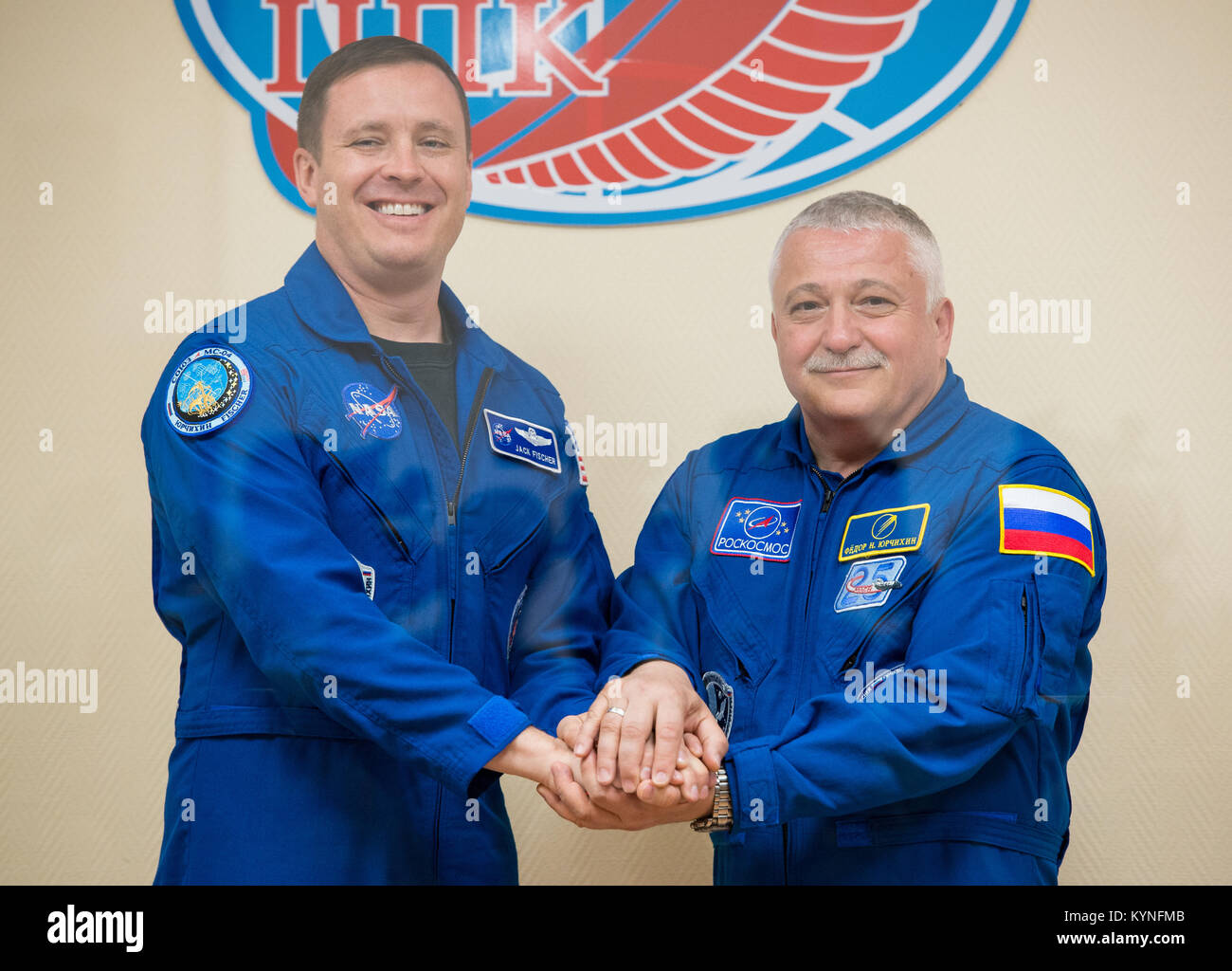 Expedition 51 Flight Engineer Jack Fischer of NASA, left, poses for a photo with Soyuz Commander Fyodor Yurchikhin of Roscosmos, right, at the conclusion of a pre-launch press conference on Wednesday, April 19, 2017 at the Cosmonaut Hotel in Baikonur, Kazakhstan. Launch of the Soyuz rocket is scheduled for April 20 and will carry Yurchikhin and Fischer into orbit to begin their four and a half month mission on the International Space Station. Photo Credit: (NASA/Aubrey Gemignani) Stock Photo