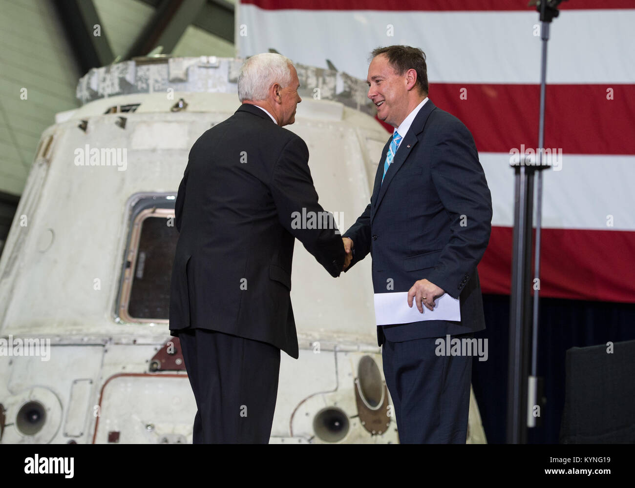 Vice President Mike Pence shakes hands with Acting NASA Administrator Robert Lightfoot before addressing NASA employees, Thursday, July 6, 2017, at the Vehicle Assembly Building at NASA’s Kennedy Space Center (KSC) in Cape Canaveral, Florida. The Vice President thanked employees for advancing American leadership in space, before going on a tour of the center that highlighted the public-private partnerships at KSC, as both NASA and commercial companies prepare to launch American astronauts from the multi-user spaceport. Photo Credit: (NASA/Aubrey Gemignani) Stock Photo