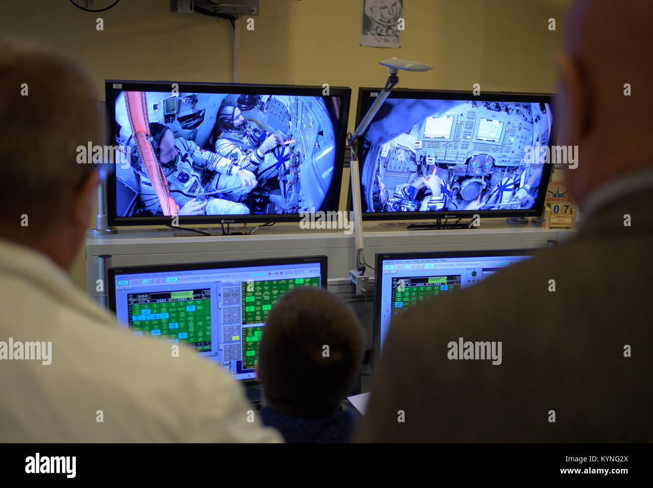 Expedition 52 crew members are seen on monitors in a control room as