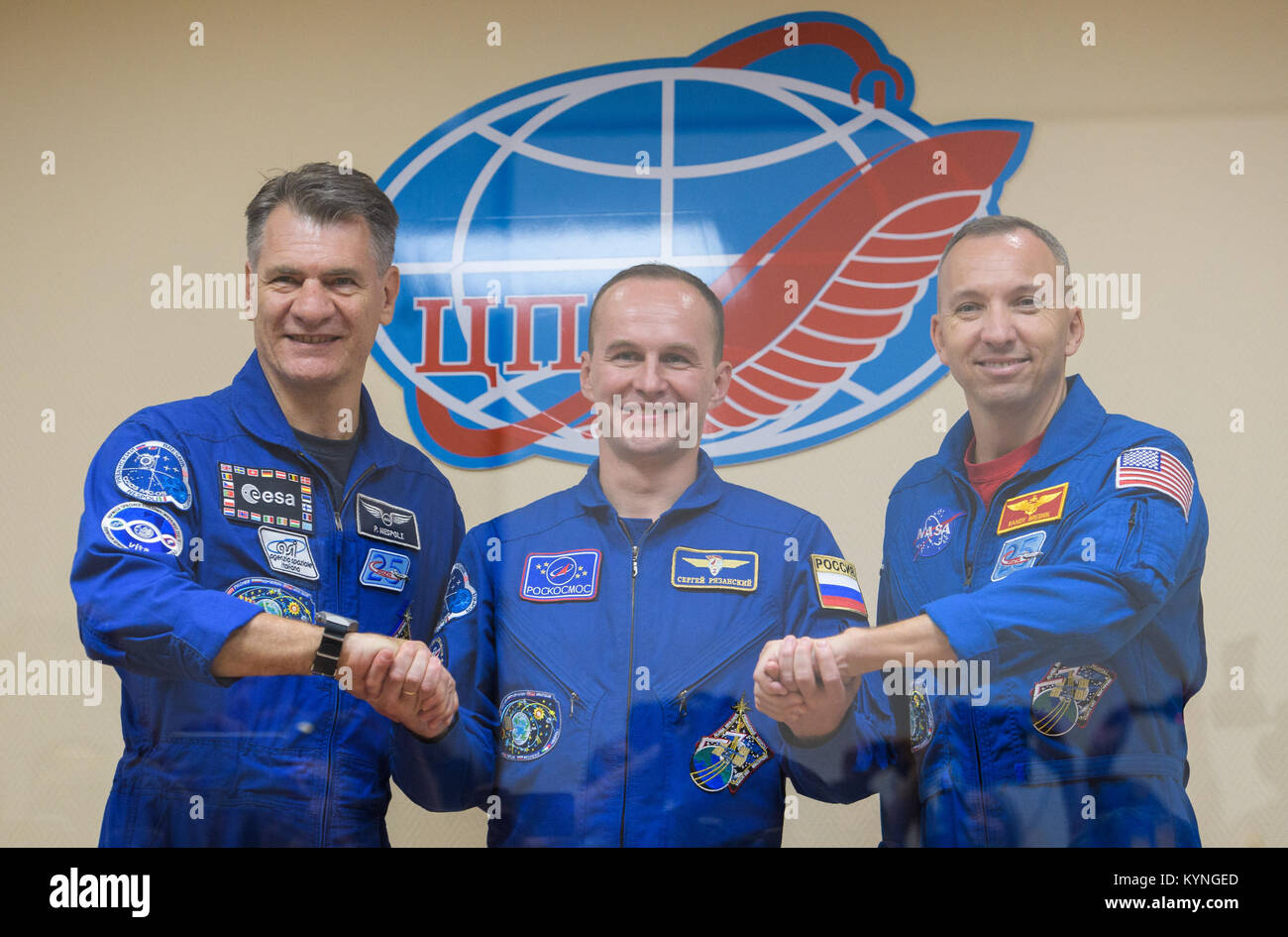 Expedition 52 flight engineer Paolo Nespoli of ESA (European Space Agency), left, flight engineer Sergei Ryazanskiy of Roscosmos, center, and flight engineer Randy Bresnik of NASA, right, pose for a picture following the conclusion of a crew press conference Thursday, July 27, 2017 at the Cosmonaut Hotel in Baikonur, Kazakhstan.  Ryazanskiy, Bresnik, and Nespoli are scheduled to launch to the International Space Station aboard the Soyuz spacecraft from the Baikonur Cosmodrome on July 28.  Photo Credit: (NASA/Joel Kowsky) Stock Photo