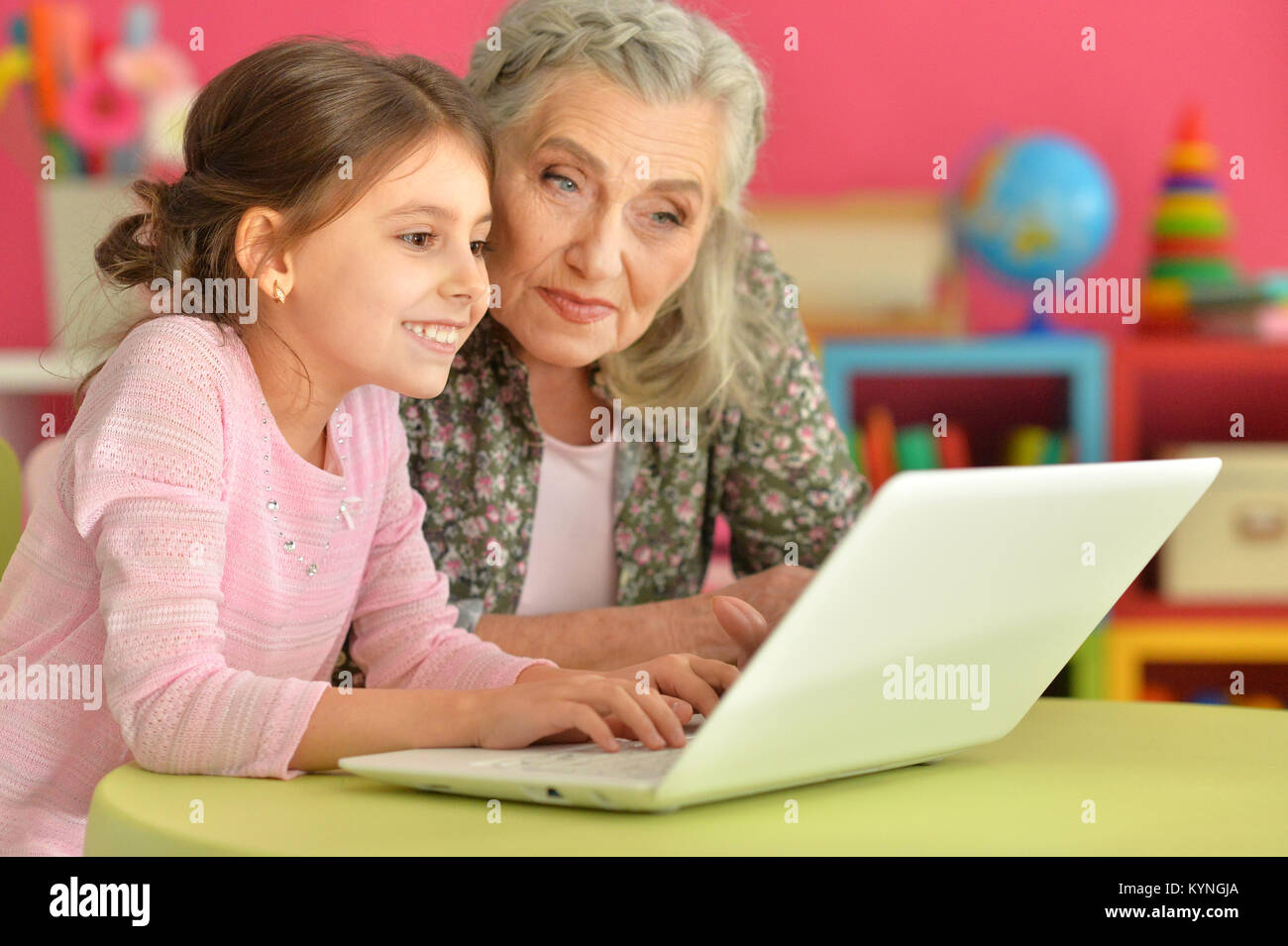 girl with grandmother using laptop Stock Photo - Alamy
