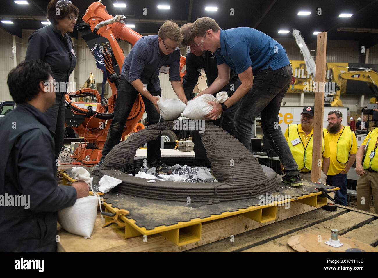 Members of the Penn State Den@Mars team of University Park, Pa., place 50 kilograms of weight on their 3D-printed dome structure in order to qualify for final testing, Saturday, Aug. 26, 2017 at Caterpillar, Inc.'s Edwards Demonstration and Learning Center in Peoria, Ill. NASA's 3D-Printed Habitat Challenge is advancing the additive construction technology needed to create sustainable housing for deep space exploration. Teams are competing in Phase 2: Level 3, for $500,000 in prize money. Teams have to 3D-print structural habitat pieces that will be crush-tested and evaluated, and teams will b Stock Photo