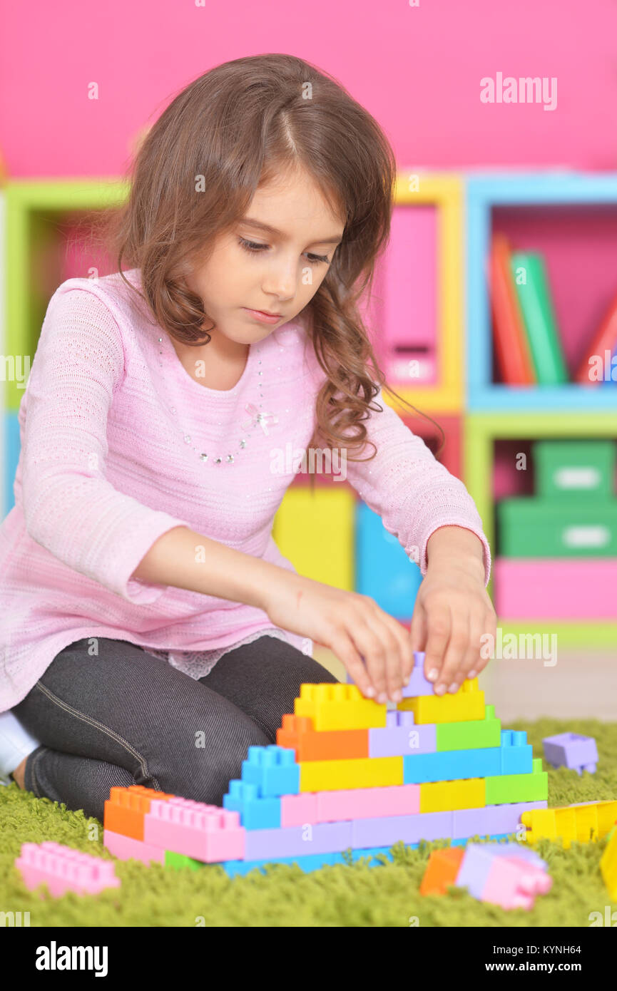 little girl playing with colorful plastic blocks Stock Photo - Alamy