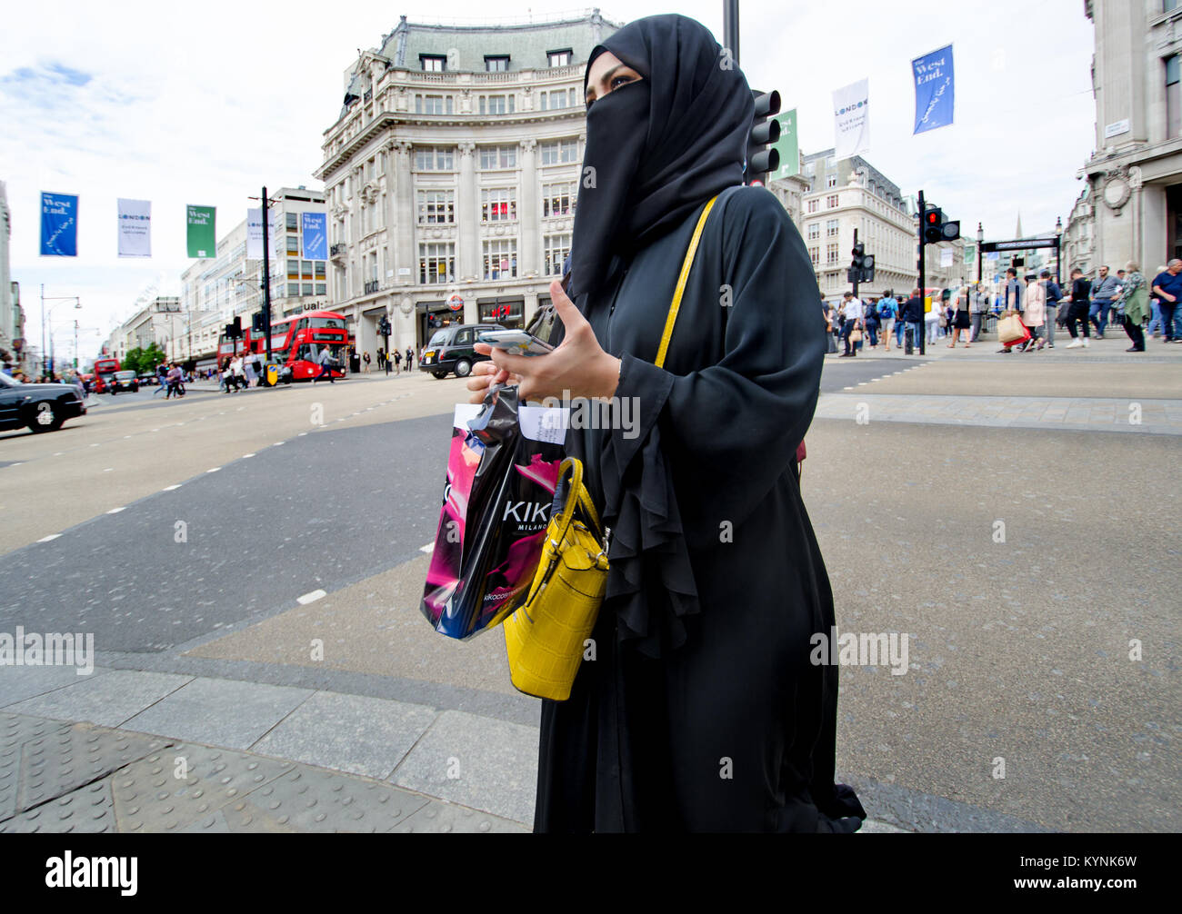 London, England, UK. Muslim woman in Oxford Circus wearing a hijab and