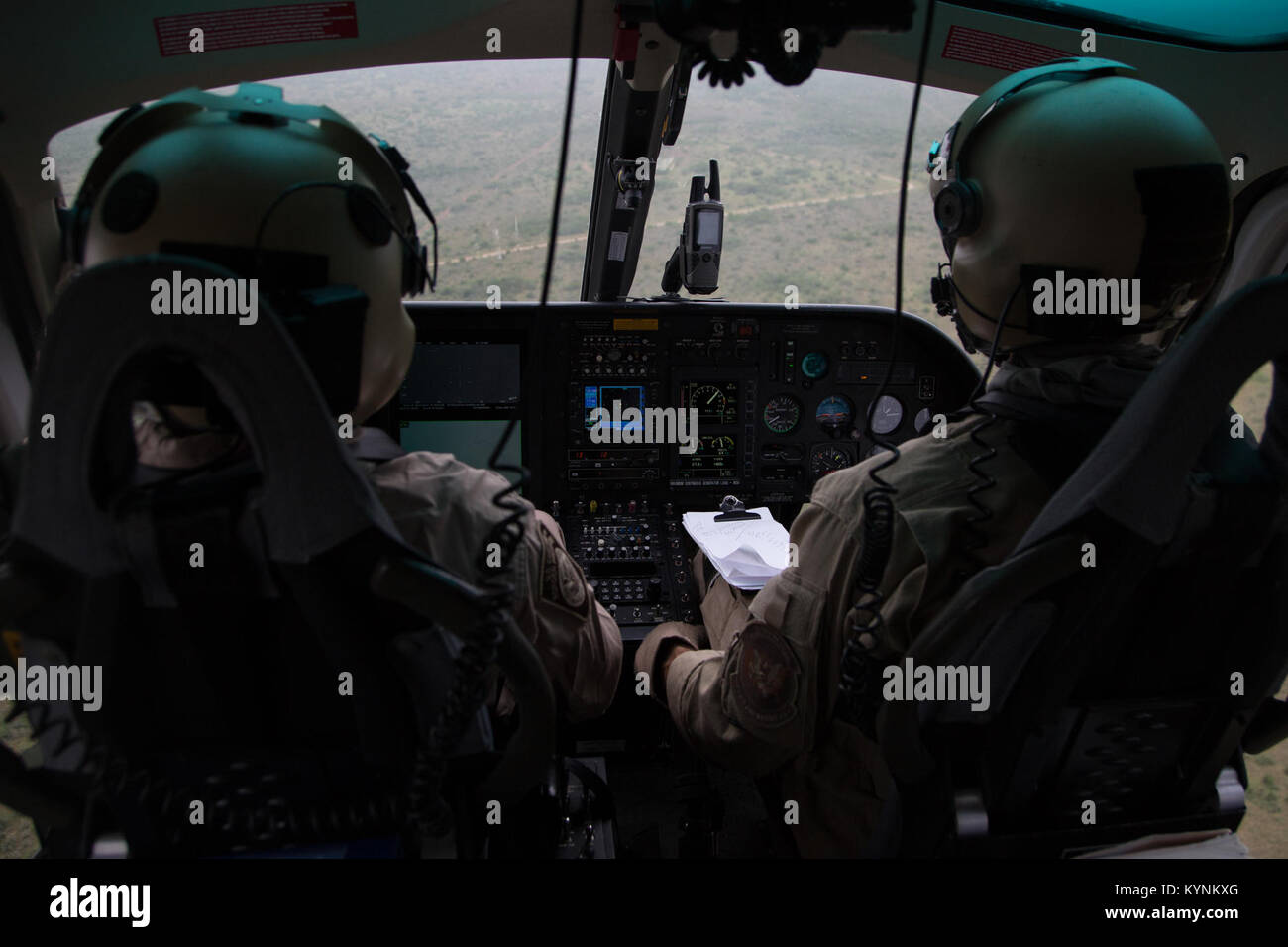 While in flight, a U.S. Customs and Border Protection, Air and Marine Operations pilot scans the area for any suspicious activity along the Laredo, Texas border.  Photographer: Donna Burton Stock Photo