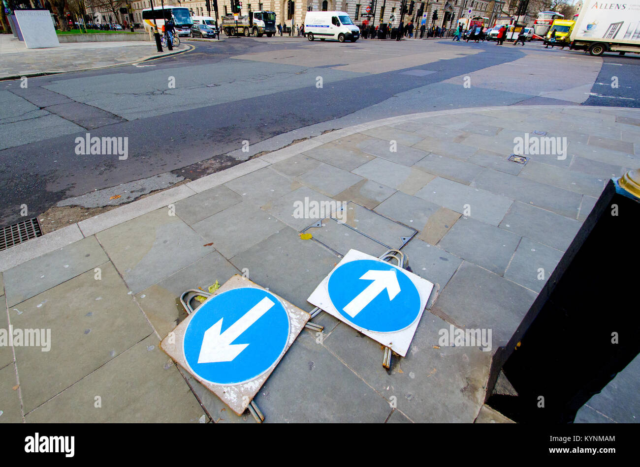 London, England, UK. Traffic arrow signs lying flat on the pavement pointing in different directions, in Parliament Square Stock Photo