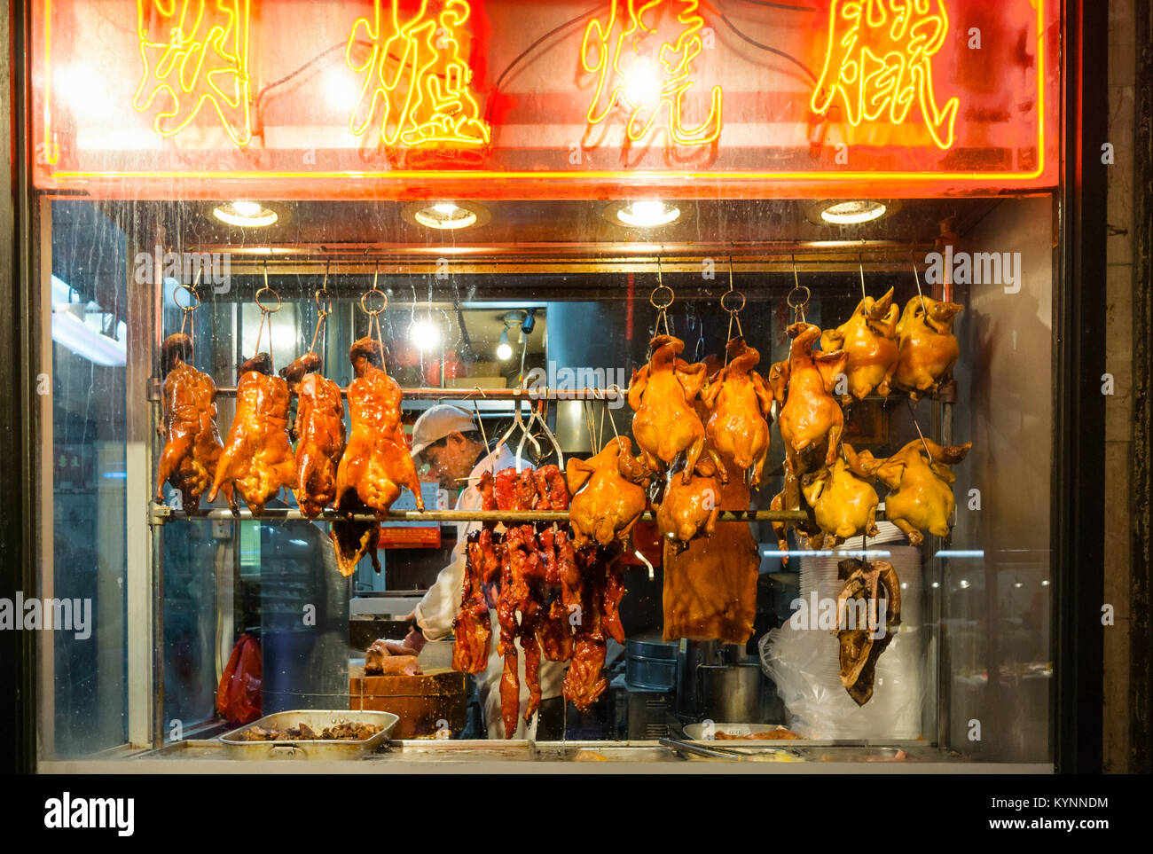 Ducks and chickens hanging in the window of a poultry store in