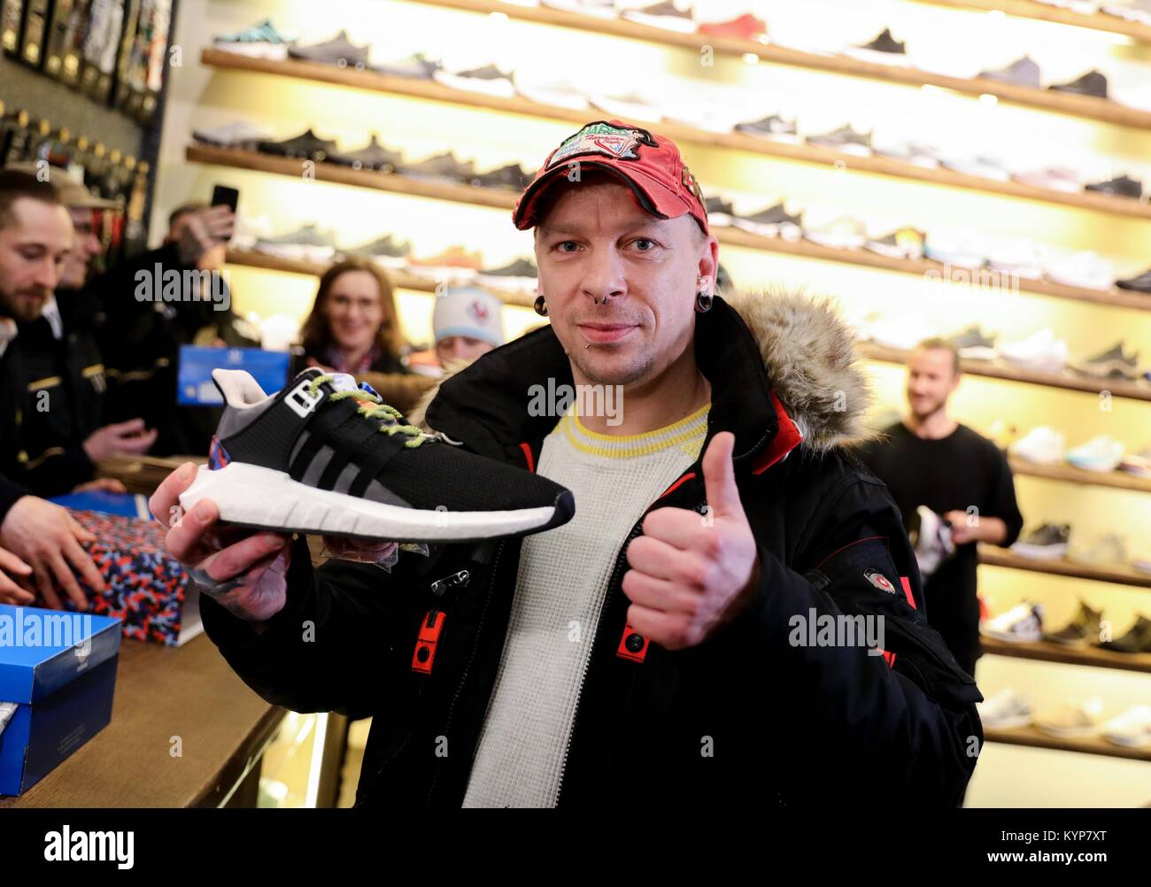 Berlin, Germany. 16th Jan, 2018. Steven Fischer shows off his new Adidas  sneakers with a built-in BVG (Berlin Transport Corporation) annual ticket  as the first buyer, in Berlin, Germany, 16 January 2018.
