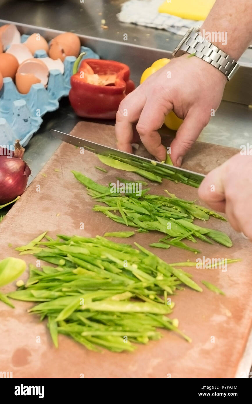 Food preparation a chef preparing food in a restaurant kitchen Stock