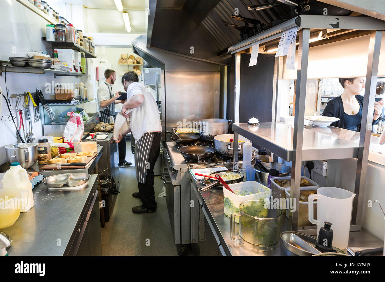 Food preparation - chefs working in a restaurant kitchen. Stock Photo