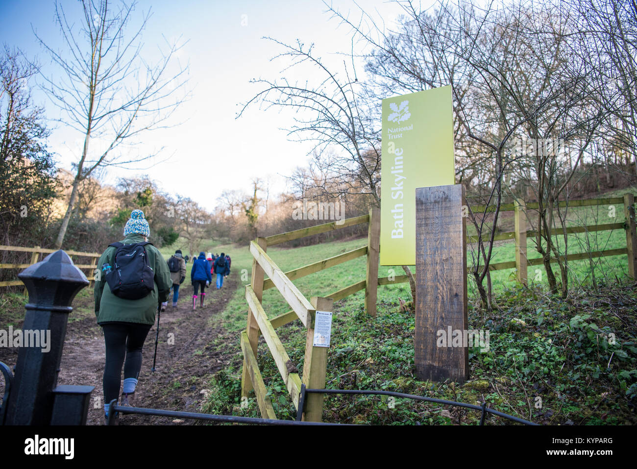 A group of walkers on a winter ramble across Bath's beautiful Skyline walking past a National Trust sign Stock Photo