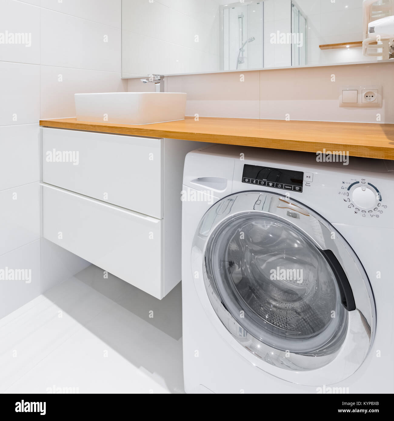 White Bathroom With Wooden Countertop Basin Cabinet And Washer