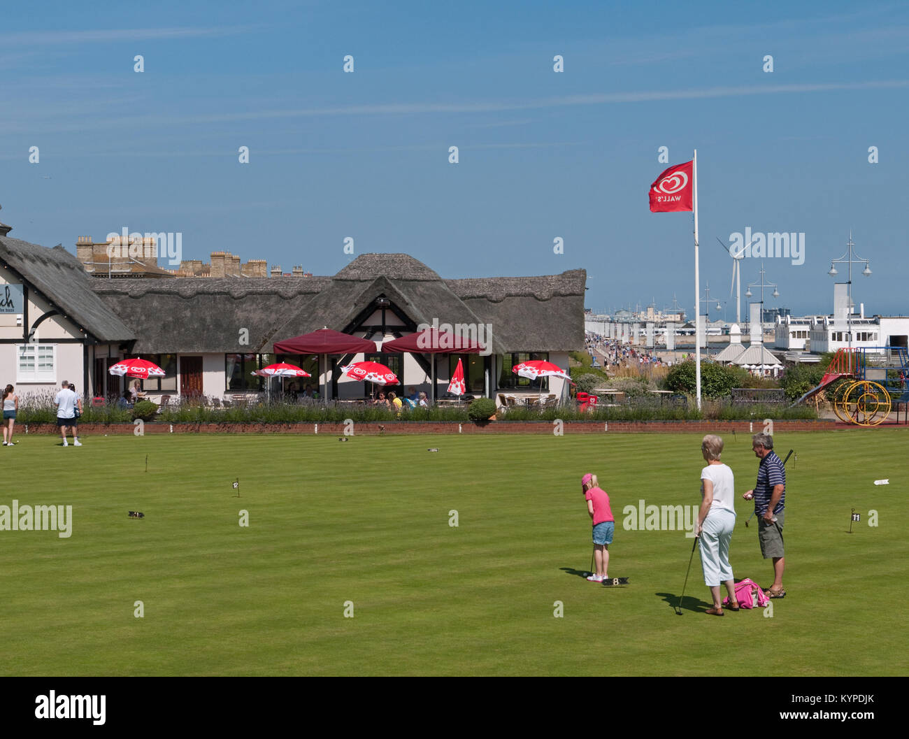 Family enjoying the Putting Green by The Thatch Restaurant on Lowestoft's Seafront, Lowestoft, Suffolk, England, UK Stock Photo