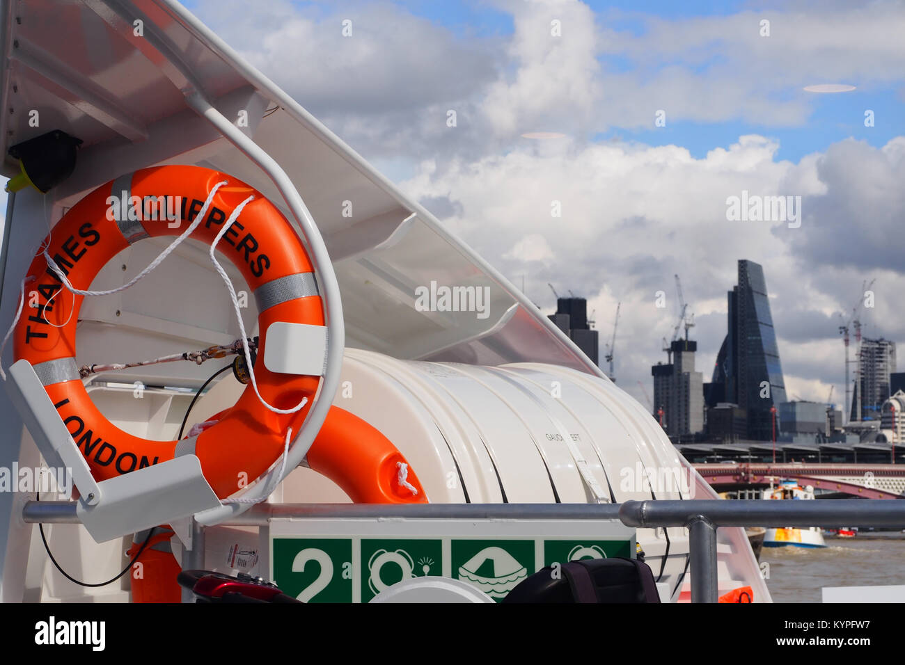 View across to the City of London from the front of a passenger cruiser boat on the river Thames Stock Photo