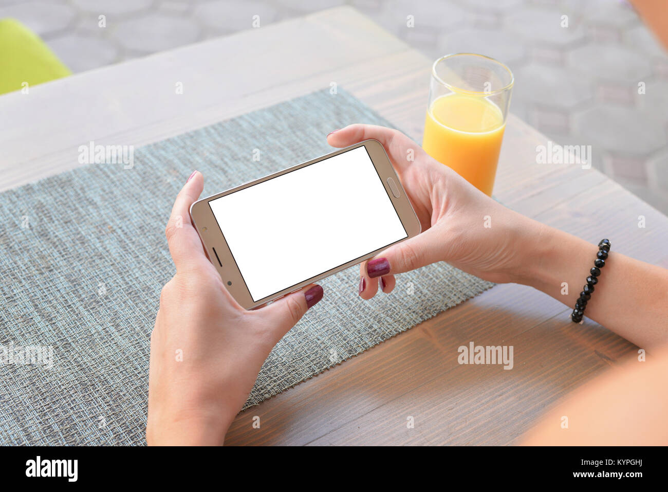 Girl watching video or play game on mobile phone in horizontal position. Isolated screen for app mockup, presentation. Close-up. Stock Photo