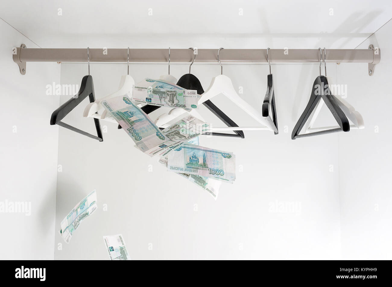 Russian rubles and empty clothes hangers in the wardrobe Stock Photo