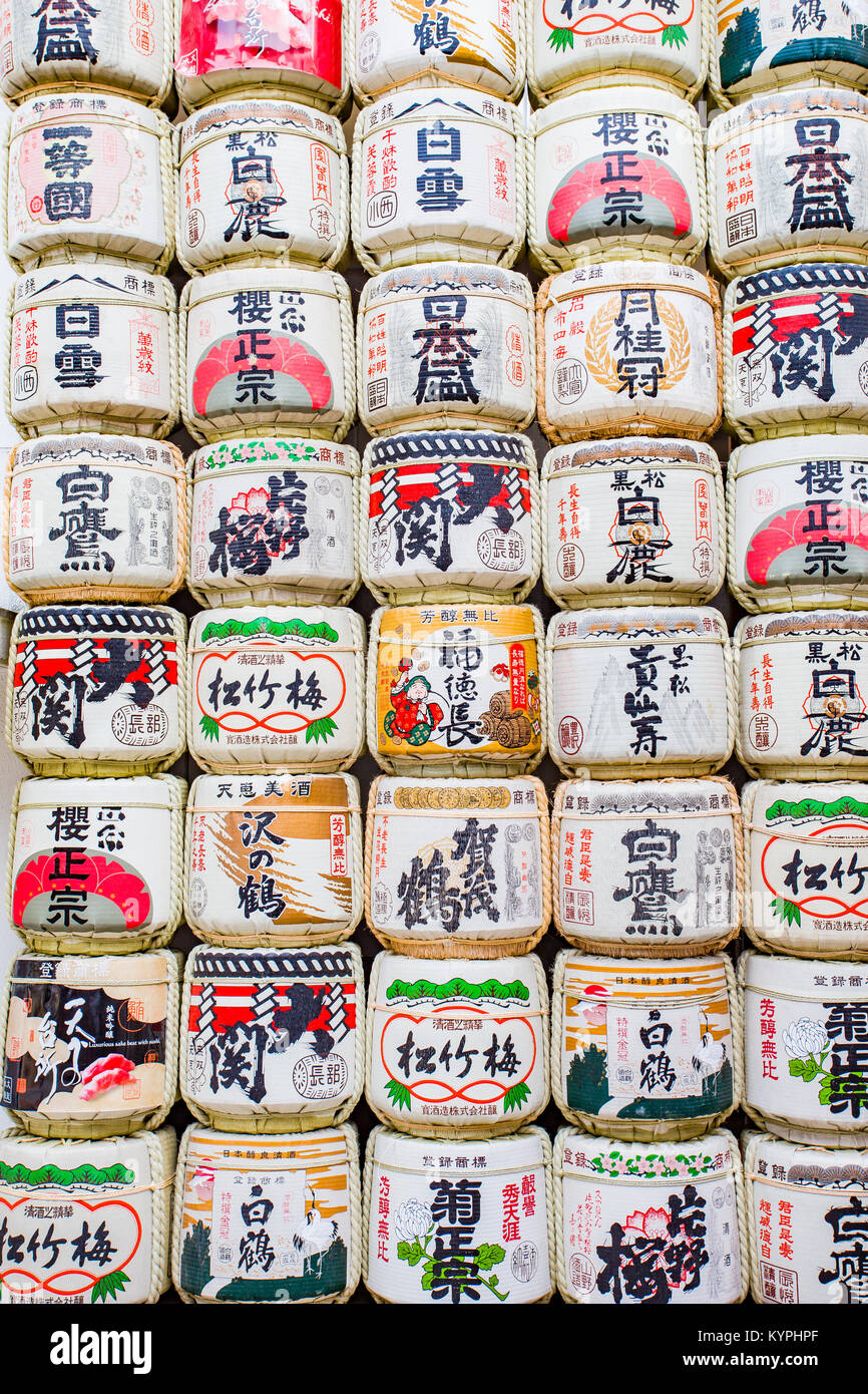 A wall of sake barrels used as decor outside a shrine in Japan Stock