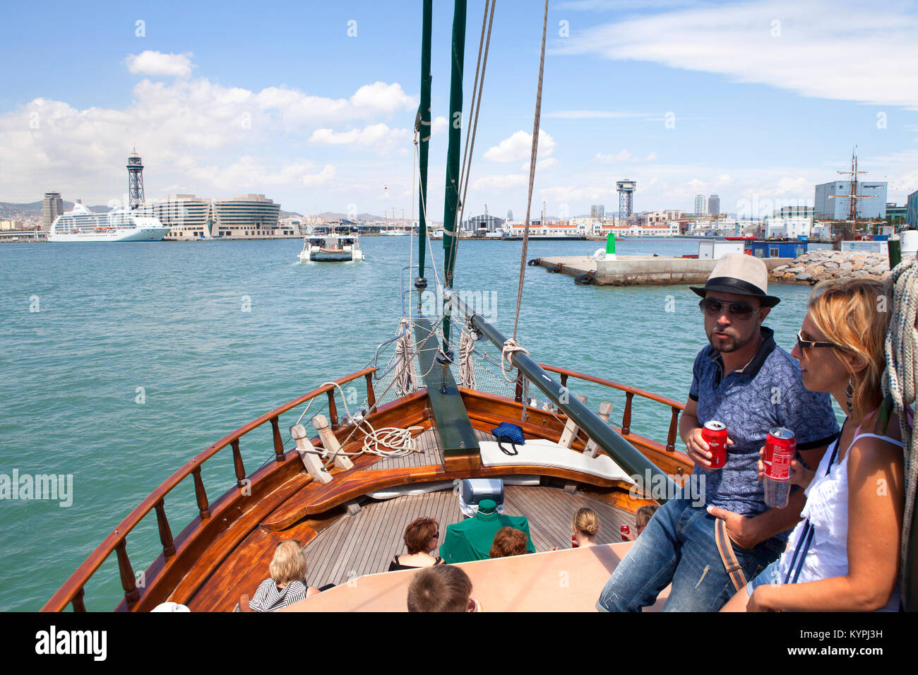 Young family sailing on board the Desigual authentic turkish wooden barquentine boat in Barcelona Port Vell harbour, Spain Stock Photo