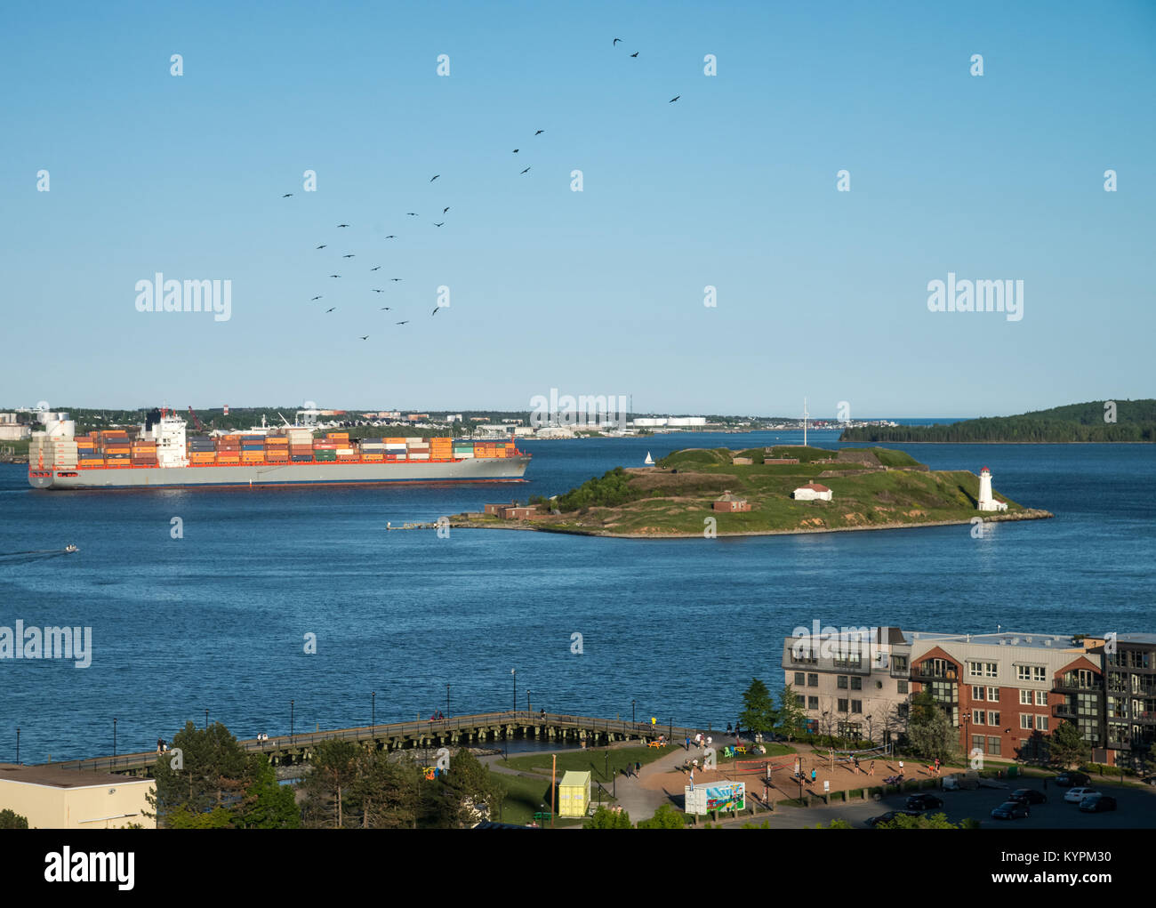Aerial view of a cargo ship navigating the harbor near Georges Island in Halifax, Nova Scotia, Canada Stock Photo