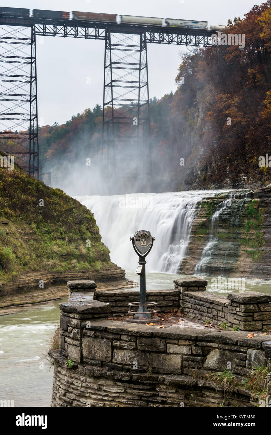 A freight train on the iron railway trestle known as the Portage Viaduct high above Upper Falls in Letchworth State - Stock Image