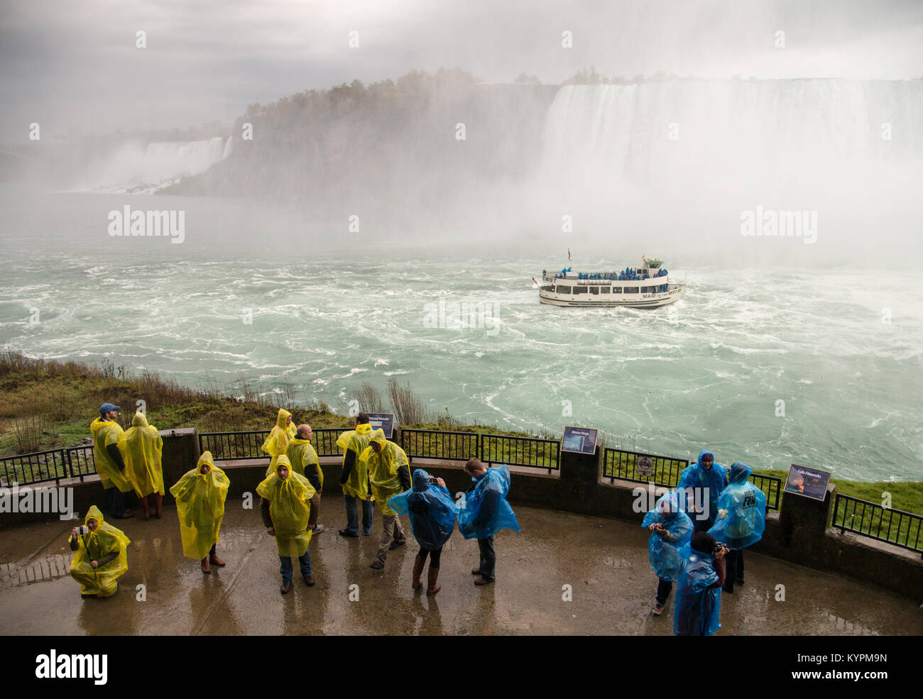 Maid of the Mist tour boat  in Niagara River viewed from viewing platform at Journey Behind the Falls attraction - Stock Image
