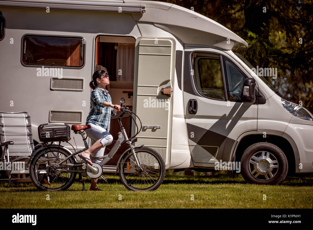 Woman on electric bike resting at the campsite. Family vacation travel, holiday trip in