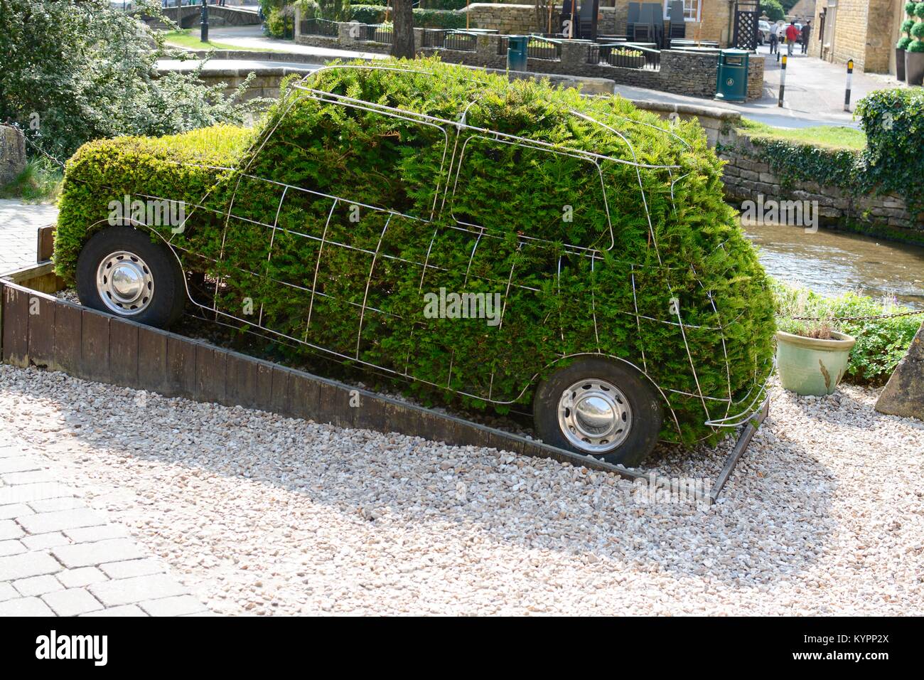 A Mini car shaped topiary bush at the Motoring Museum, Bourton-on-the-Water, Cotswolds, Gloucestershire, England Stock Photo