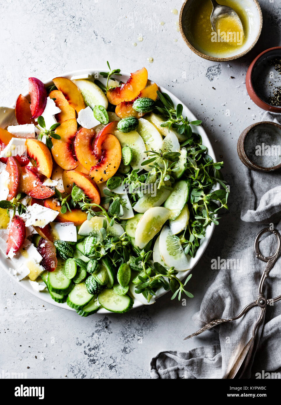 Cucamelons, peaches, cucumber, ricotta cheese and purslane salad. Stock Photo