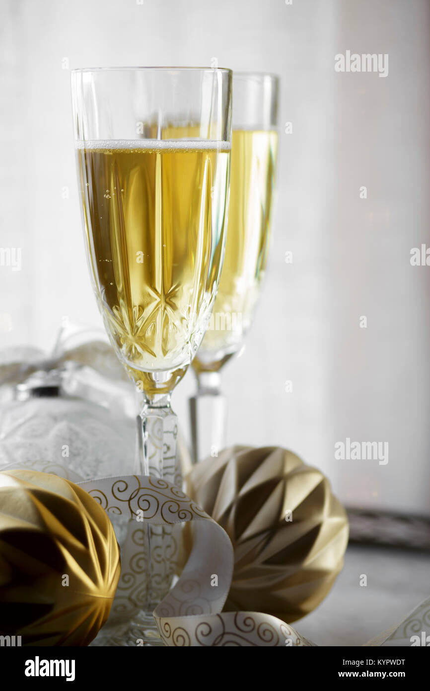 Champagne flutes alongside Christmas decorations Stock Photo - Alamy