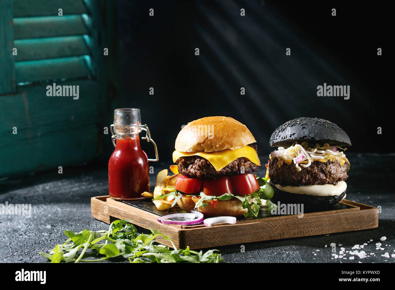 Homemade black and white buns hamburgers with beef, mozzarella cheese