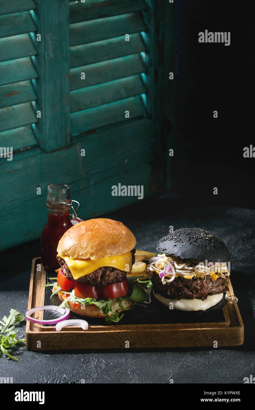 Homemade black and white buns hamburgers with beef, mozzarella cheese